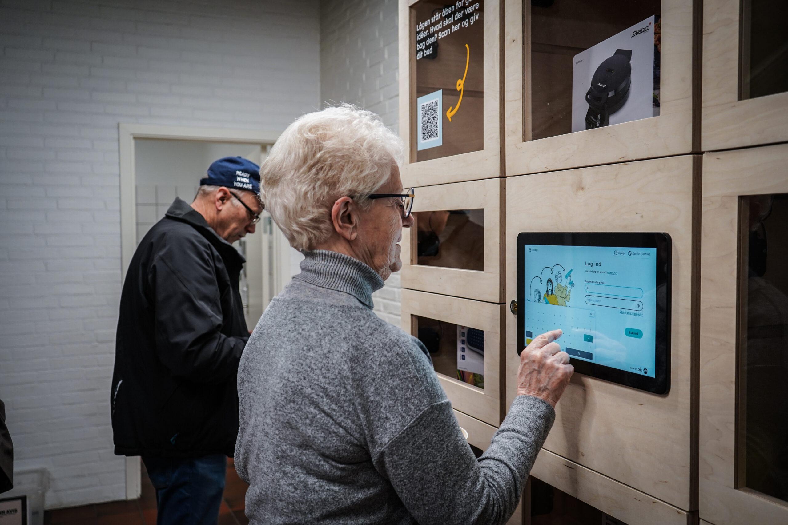 Photo of senior citizen using sharing station